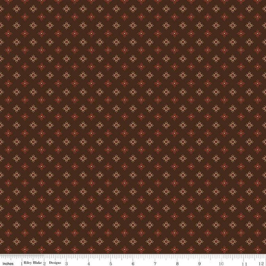 Image of John Wayne American West Sun Brown quilting cotton fabric by Riley Blake Official Product for Riley Blake Designs. Features suns on a brown background. Cute Little Fabric Shop