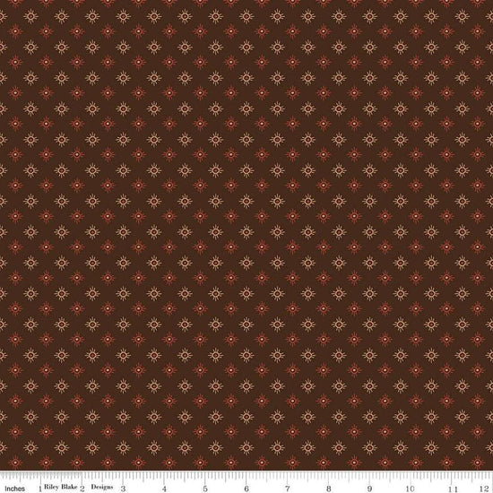 Image of John Wayne American West Sun Brown quilting cotton fabric by Riley Blake Official Product for Riley Blake Designs. Features suns on a brown background. Cute Little Fabric Shop