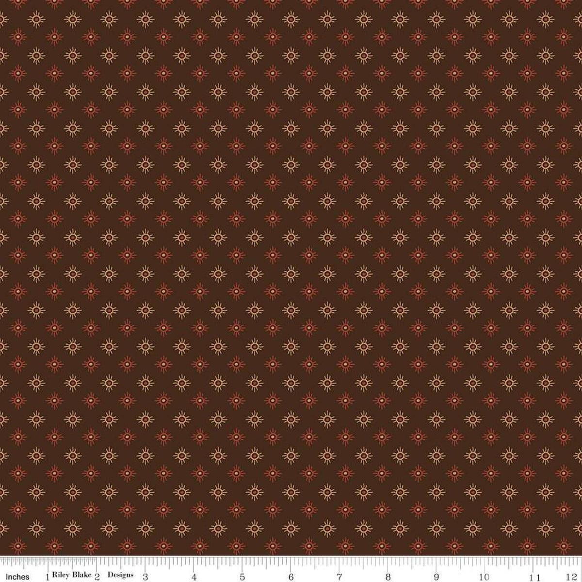 Image of John Wayne American West Sun Brown quilting cotton fabric by Riley Blake Official Product for Riley Blake Designs. Features suns on a brown background. Cute Little Fabric Shop