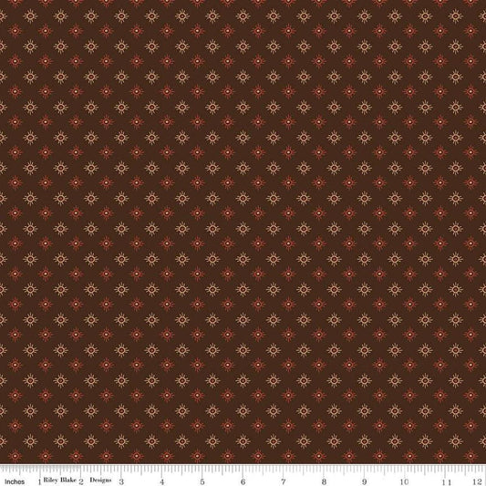 Image of John Wayne American West Sun Brown quilting cotton fabric by Riley Blake Official Product for Riley Blake Designs. Features suns on a brown background. Cute Little Fabric Shop