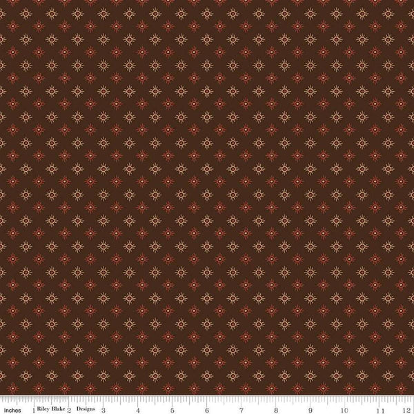 Image of John Wayne American West Sun Brown quilting cotton fabric by Riley Blake Official Product for Riley Blake Designs. Features suns on a brown background. Cute Little Fabric Shop