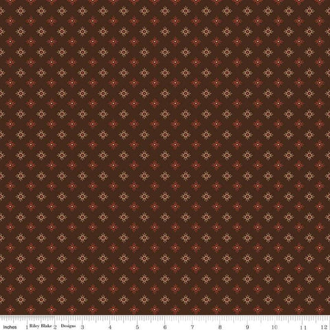 Image of John Wayne American West Sun Brown quilting cotton fabric by Riley Blake Official Product for Riley Blake Designs. Features suns on a brown background. Cute Little Fabric Shop