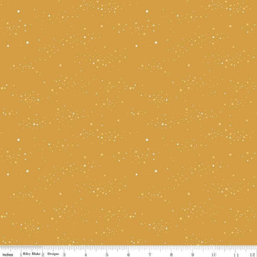 Image of Essence Starlight Golden quilting cotton fabric by Fran Gulick for Riley Blake Designs. Features stars on a yellow background. Cute Little Fabric Shop