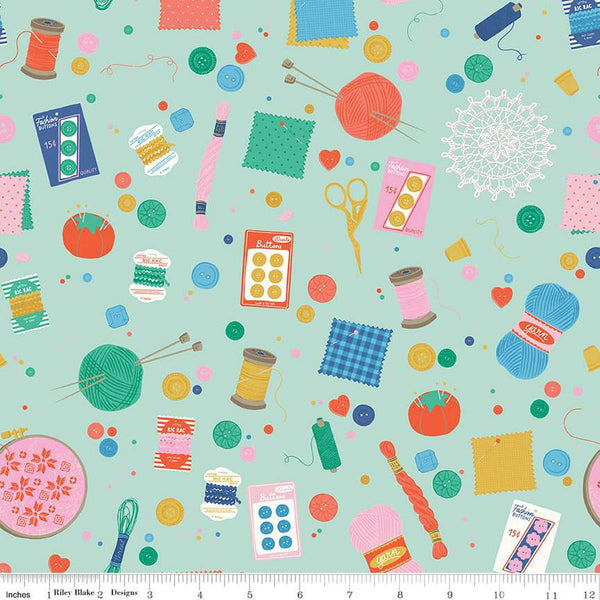 Image of Hand Made Notions Mint quilting cotton fabric by Amber Kemp-Gerstel for Riley Blake Designs. Features sewing supplies on a green background. Cute Little Fabric Shop