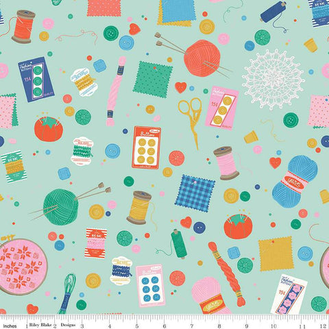Image of Hand Made Notions Mint quilting cotton fabric by Amber Kemp-Gerstel for Riley Blake Designs. Features sewing supplies on a green background. Cute Little Fabric Shop