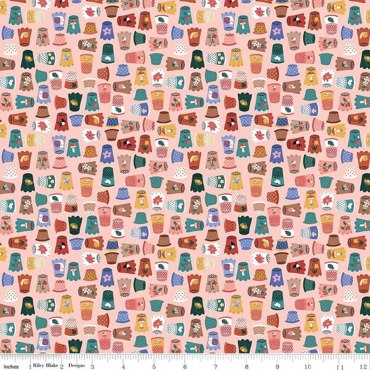 Image of Thimbelina & The Sewing Fairies Thimble Collection Apricot Mist quilting cotton fabric by Jennifer Long for Riley Blake Designs. Features thimbles on a pink background. Cute Little Fabric Shop