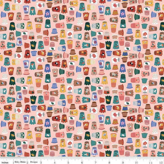 Image of Thimbelina & The Sewing Fairies Thimble Collection Apricot Mist quilting cotton fabric by Jennifer Long for Riley Blake Designs. Features thimbles on a pink background. Cute Little Fabric Shop