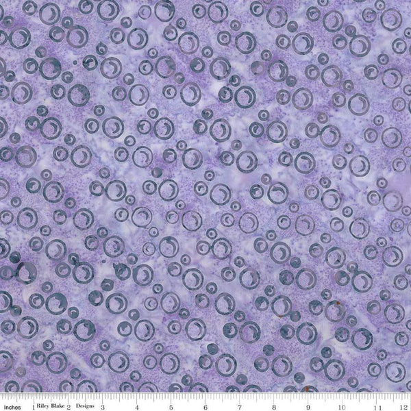 Image of Expressions Batiks Radiant Flourish Lavender Blue quilting cotton fabric by The RBD Designers for Riley Blake Designs. Features bubbles on a purple background. Cute Little Fabric Shop