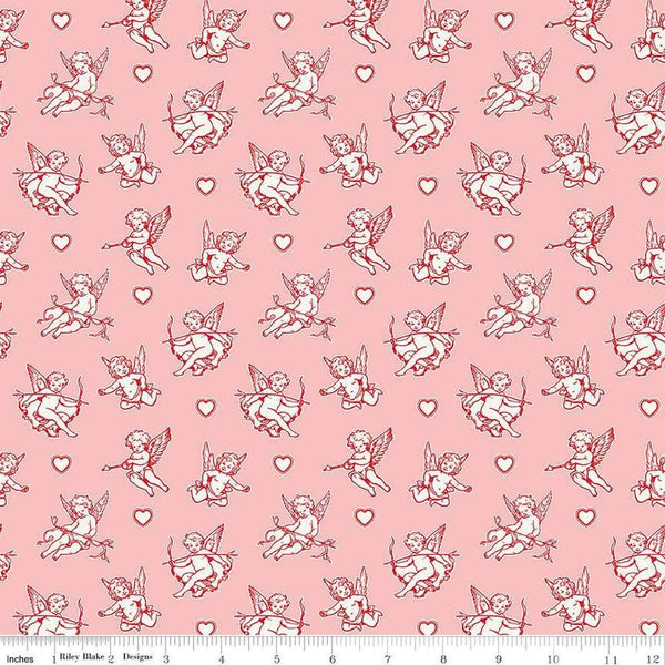 Image of Letters to Cupid Cupids Pink quilting cotton fabric by My Mind&#39;s Eye for Riley Blake Designs. Features cupids on a pink background. Cute Little Fabric Shop