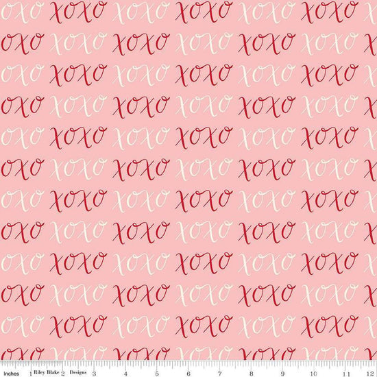 Image of Letters to Cupid XOXO Pink quilting cotton fabric by My Mind's Eye for Riley Blake Designs. Features writing on a pink background. Cute Little Fabric Shop