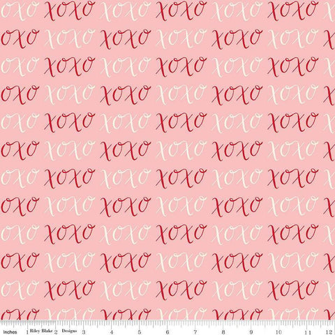 Image of Letters to Cupid XOXO Pink quilting cotton fabric by My Mind&#39;s Eye for Riley Blake Designs. Features writing on a pink background. Cute Little Fabric Shop