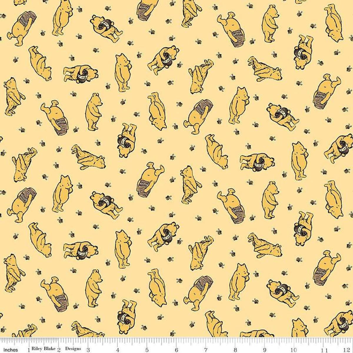 Image of Winnie the Pooh Toss Sunshine quilting cotton fabric by Echo Park Paper Co for Riley Blake Designs. Features Pooh on a yellow background. Cute Little Fabric Shop