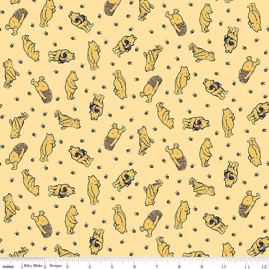 Image of Winnie the Pooh Toss Sunshine quilting cotton fabric by Echo Park Paper Co for Riley Blake Designs. Features Pooh on a yellow background. Cute Little Fabric Shop