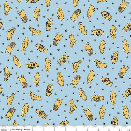 Image of Winnie the Pooh Toss Blue quilting cotton fabric by Echo Park Paper Co for Riley Blake Designs. Features Pooh on a blue background. Cute Little Fabric Shop