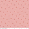 Image of Sweet Cotton Tales Twirls & Ties Rose quilting cotton fabric by Cayla Naylor for Riley Blake Designs. Features bows on a pink background. Cute Little Fabric Shop