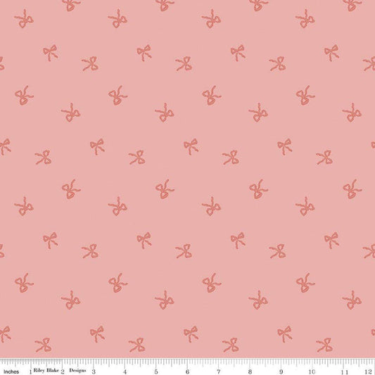 Image of Sweet Cotton Tales Twirls & Ties Rose quilting cotton fabric by Cayla Naylor for Riley Blake Designs. Features bows on a pink background. Cute Little Fabric Shop