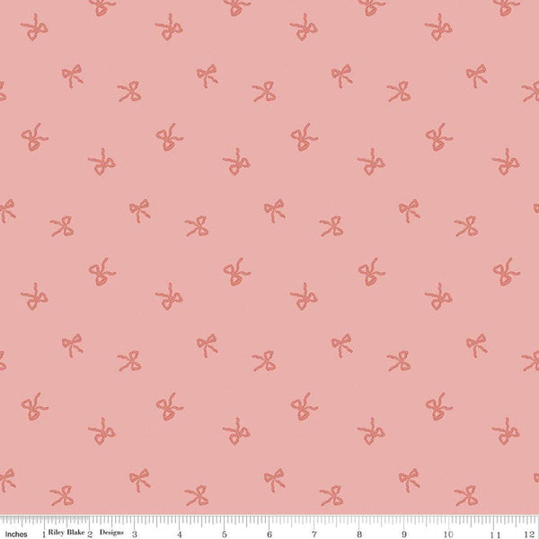 Image of Sweet Cotton Tales Twirls & Ties Rose quilting cotton fabric by Cayla Naylor for Riley Blake Designs. Features bows on a pink background. Cute Little Fabric Shop
