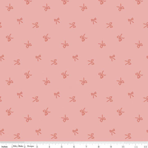 Image of Sweet Cotton Tales Twirls & Ties Rose quilting cotton fabric by Cayla Naylor for Riley Blake Designs. Features bows on a pink background. Cute Little Fabric Shop