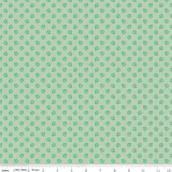 Image of Farmer's Daughter Clover Sage quilting cotton fabric by Lori Holt for Riley Blake Designs. Features plants on a green background. Cute Little Fabric Shop