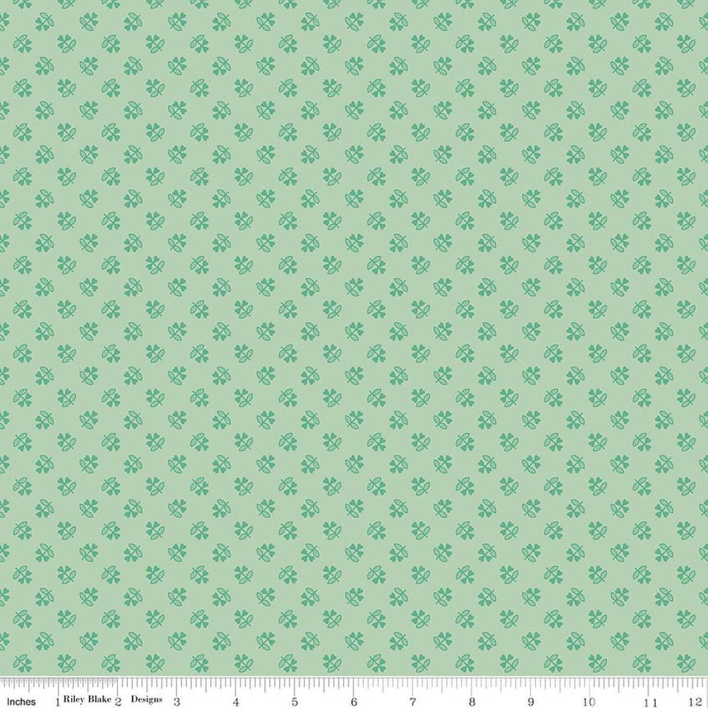 Image of Farmer's Daughter Clover Sage quilting cotton fabric by Lori Holt for Riley Blake Designs. Features plants on a green background. Cute Little Fabric Shop