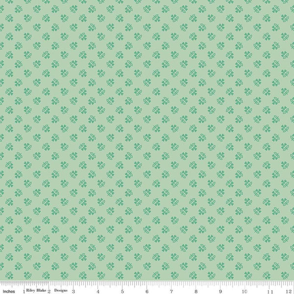 Image of Farmer's Daughter Clover Sage quilting cotton fabric by Lori Holt for Riley Blake Designs. Features plants on a green background. Cute Little Fabric Shop