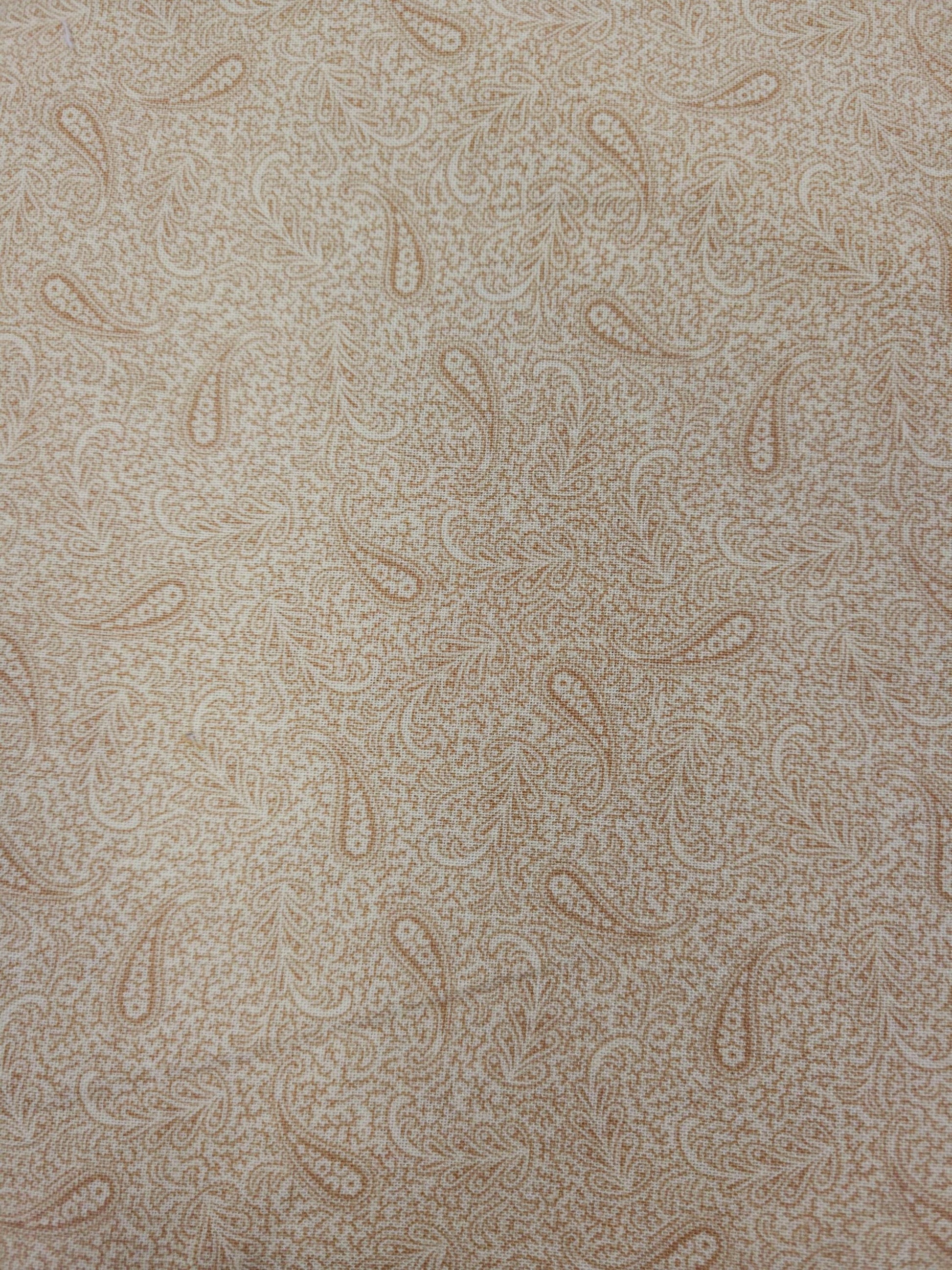 a repeating pattern of paisley designs in various shades of brown and beige.