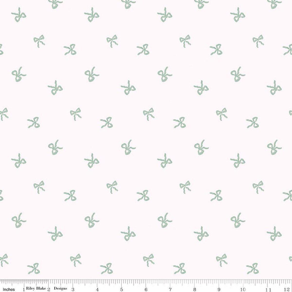 Image of Sweet Cotton Tales Twirls & Ties Cream quilting cotton fabric by Cayla Naylor for Riley Blake Designs. Features bows on a white background. Cute Little Fabric Shop