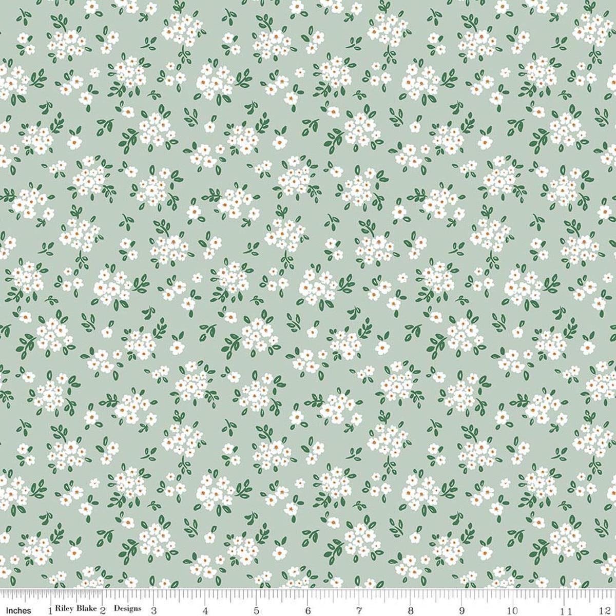 Image of Sweet Cotton Tales Blooming Bliss Sage quilting cotton fabric by Cayla Naylor for Riley Blake Designs. Features flowers on a green background. Cute Little Fabric Shop