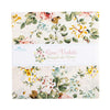The image is a square fabric with a floral pattern, featuring various shades of green, pink, and yellow flowers. The fabric appears to be a quilt or a textile product.