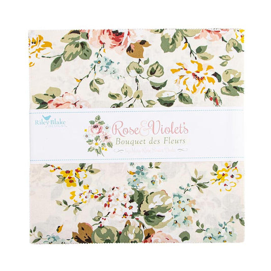 The image is a square fabric with a floral pattern, featuring various shades of green, pink, and yellow flowers. The fabric appears to be a quilt or a textile product.