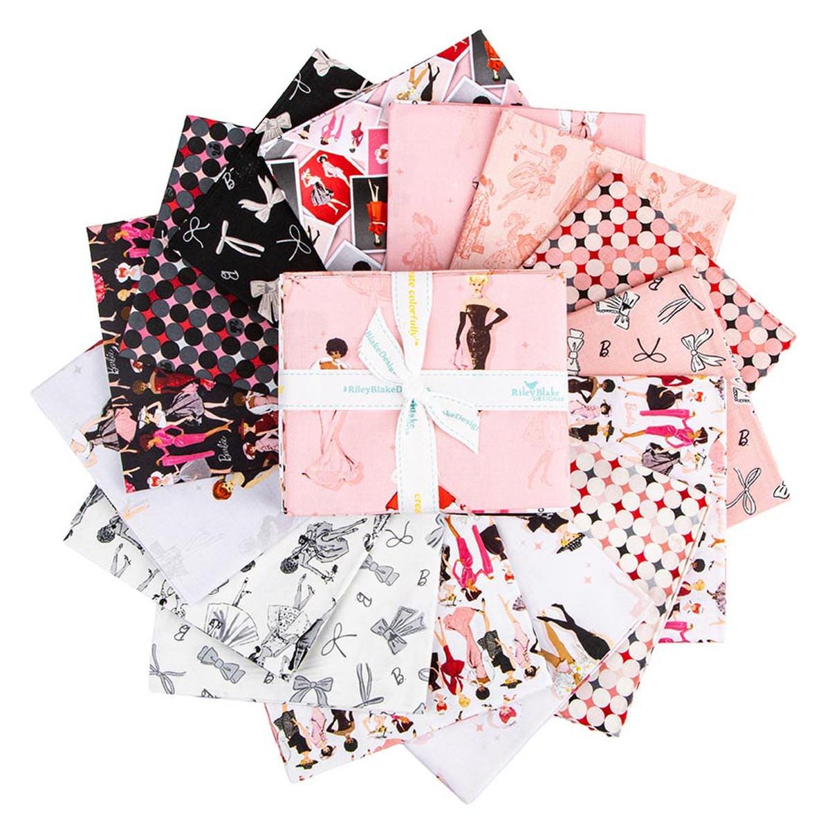 a collection of various fabric pieces with different patterns and designs, including a pink fabric with a bow and a white fabric with a black and white pattern.