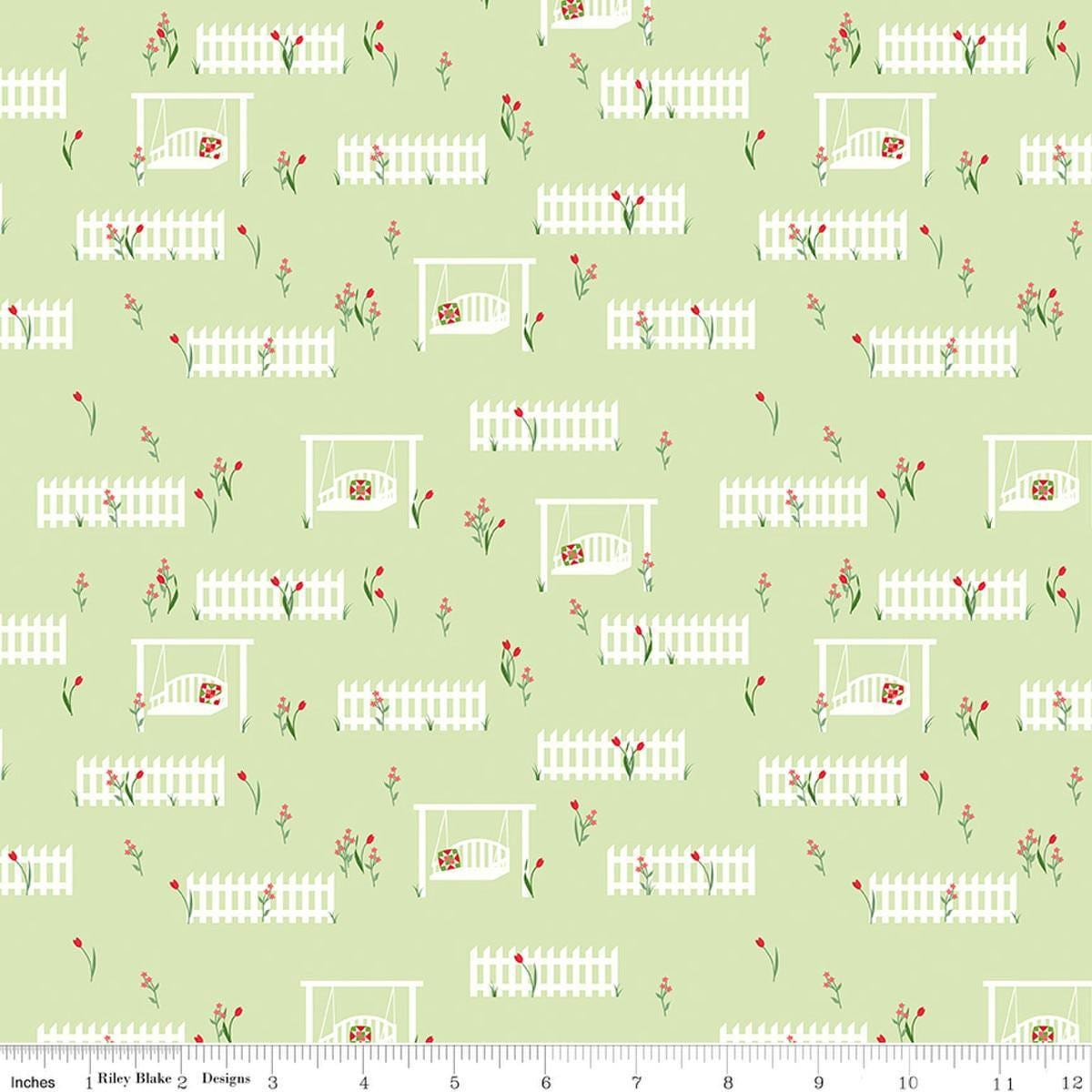 Image of Front Porch Porch Swings Green quilting cotton fabric by Jill Finley for Riley Blake Designs. Features garden fences on a green background. Cute Little Fabric Shop.
