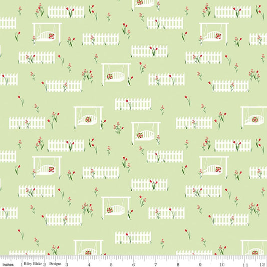 Image of Front Porch Porch Swings Green quilting cotton fabric by Jill Finley for Riley Blake Designs. Features garden fences on a green background. Cute Little Fabric Shop.