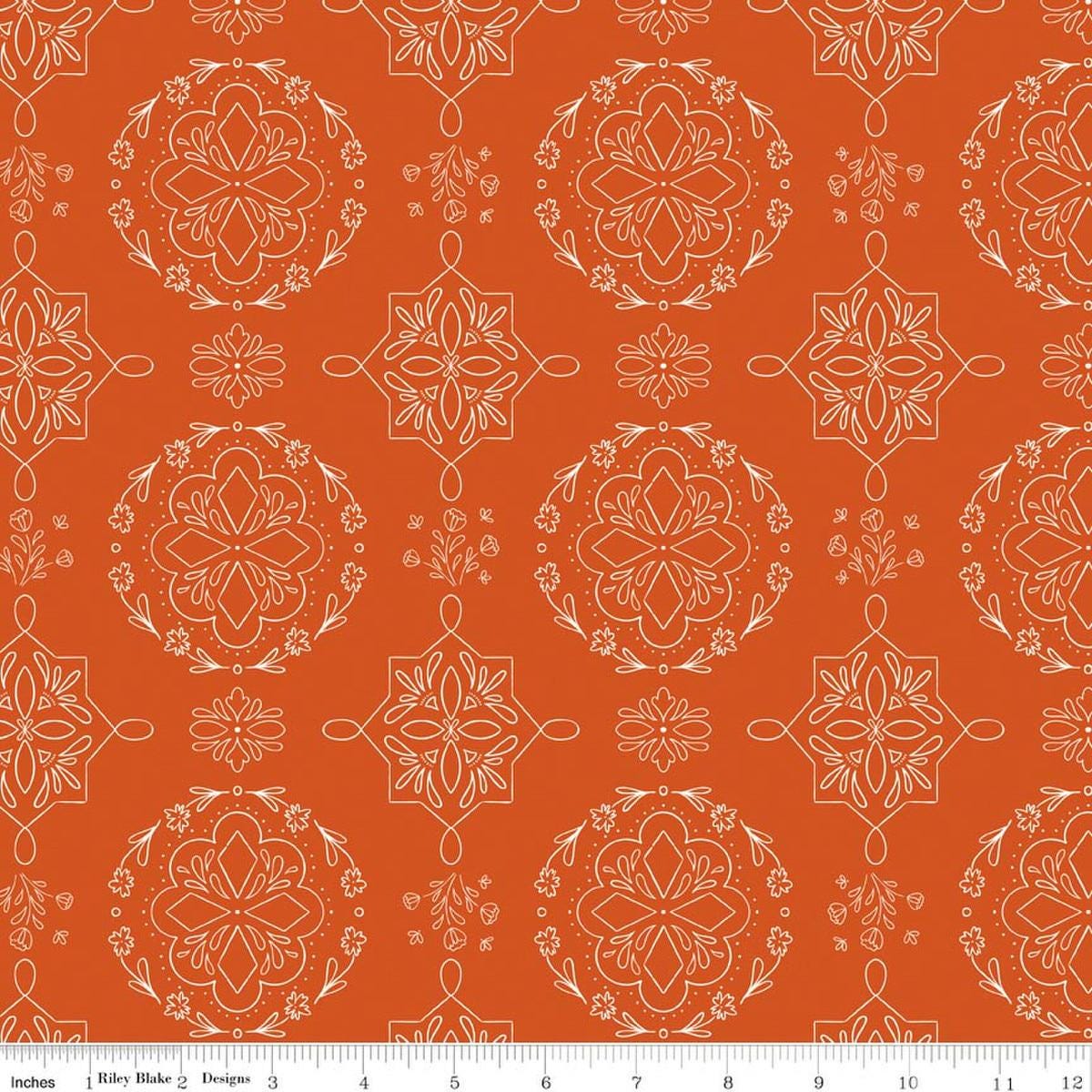 Image of Homage Doilies Pumpkin quilting cotton fabric by Fran Gulick for Riley Blake Designs. Features printed lace on an orange background. Cute Little Fabric Shop.