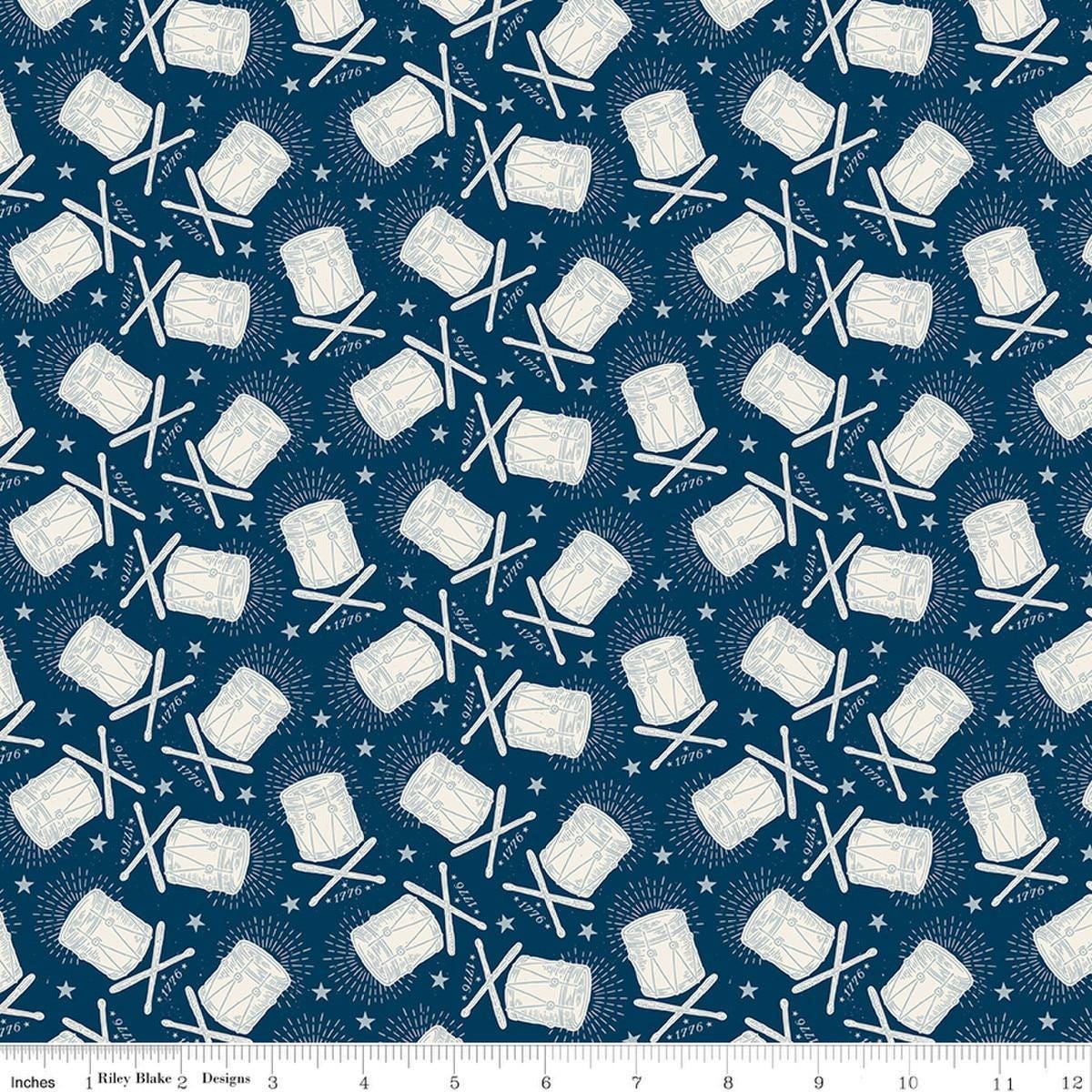Image of Independence Drums Oxford quilting cotton fabric by The RBD Designers for Riley Blake Designs. Features drums on a blue background. Cute Little Fabric Shop.