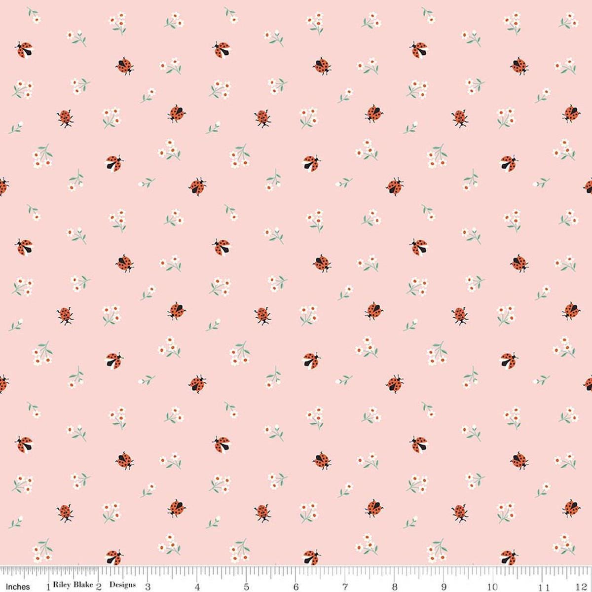 Image of Meadow Moments Ladybugs Pink quilting cotton pattern by Little Forest Atelier for Riley Blake Designs. Features flowers on a pink background. Cute Little Fabric Shop.