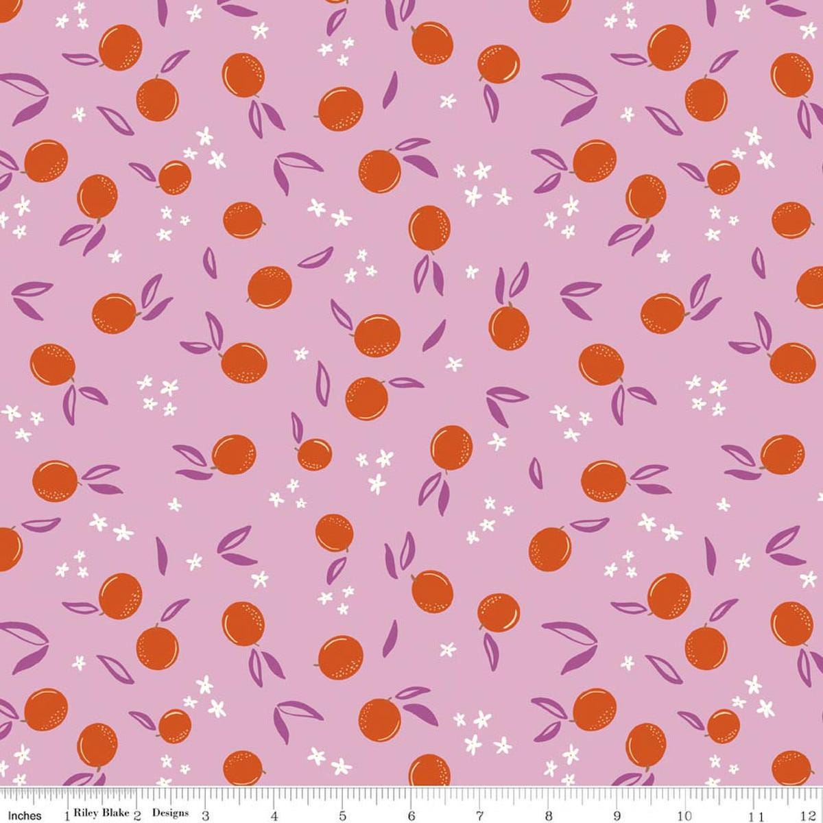 Image of Homage Oranges Lavender quilting cotton fabric by Fran Gulick for Riley Blake Designs. Features oranges on a pink background. Cute Little Fabric Shop.