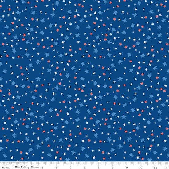 Image of Firecracker Stars Blue quilting cotton fabric by My Mind's Eye for Riley Blake Designs. Features stars on a blue background. Cute Little Fabric Shop.