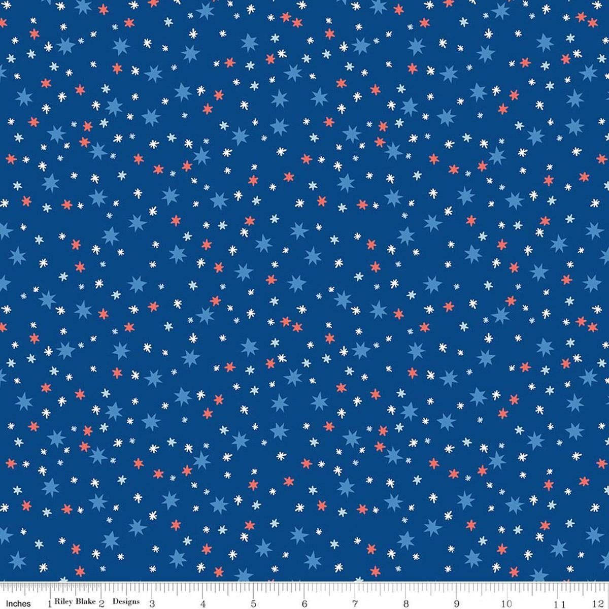 Image of Firecracker Stars Blue quilting cotton fabric by My Mind's Eye for Riley Blake Designs. Features stars on a blue background. Cute Little Fabric Shop.
