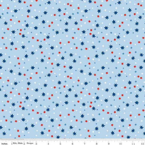 Image of Firecracker Stars Frost quilting cotton fabric by My Mind's Eye for Riley Blake Designs. Features stars on a blue background. Cute Little Fabric Shop.