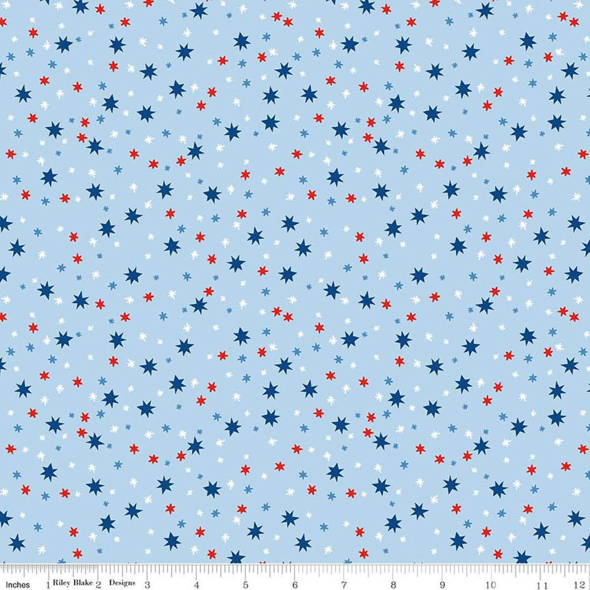 Image of Firecracker Stars Frost quilting cotton fabric by My Mind's Eye for Riley Blake Designs. Features stars on a blue background. Cute Little Fabric Shop.