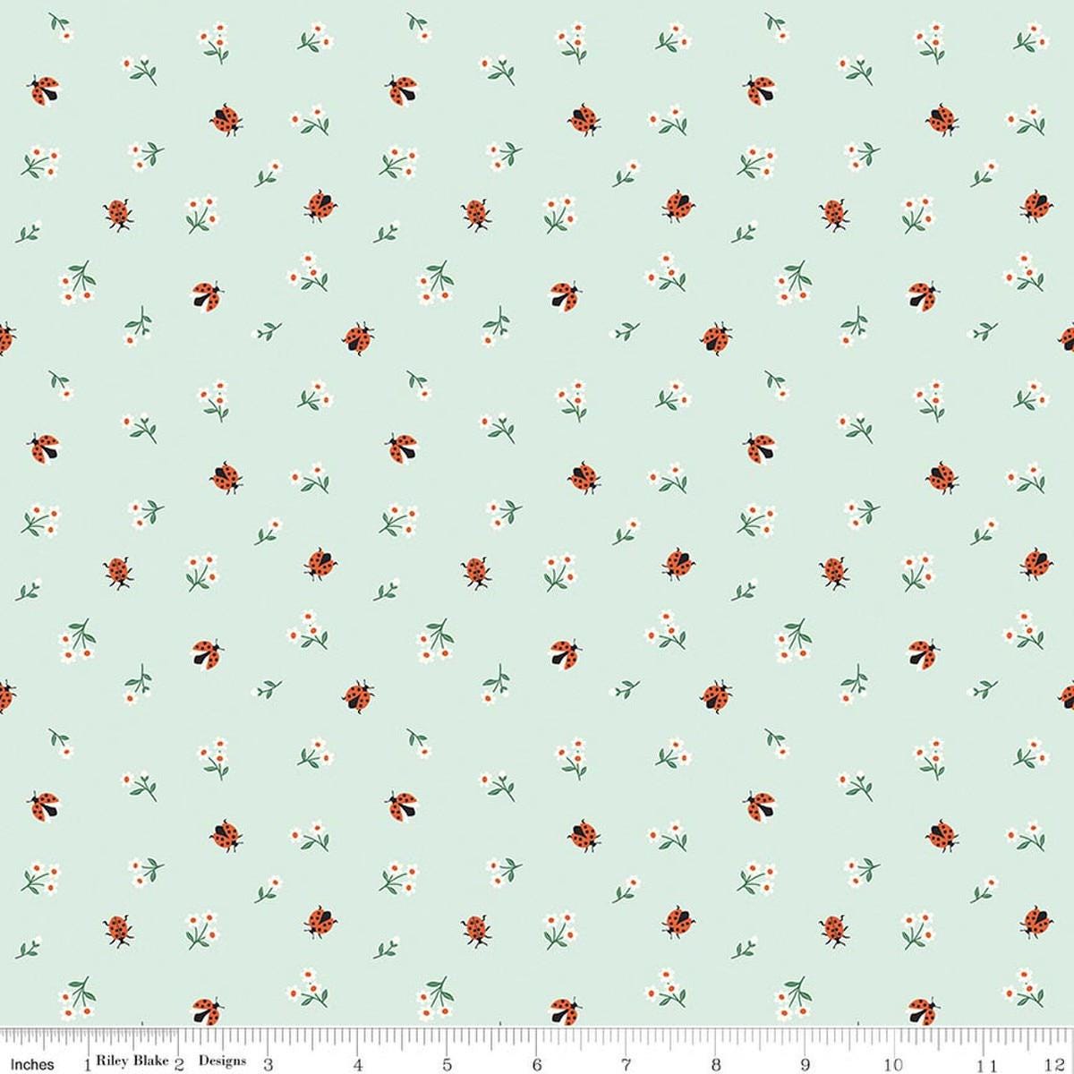 Image of Meadow Moments Ladybugs Mint quilting cotton pattern by Little Forest Atelier for Riley Blake Designs. Features flowers on a green background. Cute Little Fabric Shop.