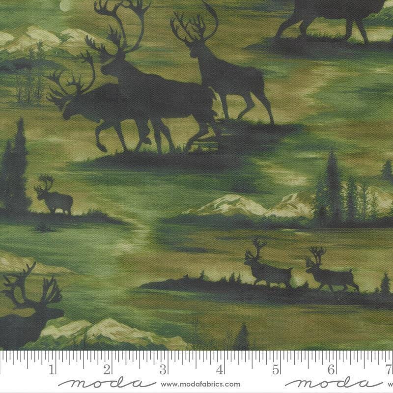 Image of Wild Blue Yonder Silhouettes Pine quilting cotton fabric by Moda Fabrics. Features animals on a green background. Cute Little Fabric Shop.