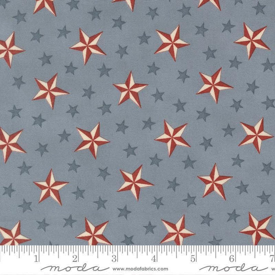 Image of America 250 Years Tossed Stars Steel Blue quilting cotton fabric by Deb Strain for Moda Fabrics. Features stars on a blue background. Cute Little Fabric Shop.