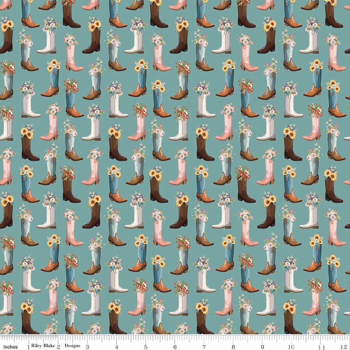 Image of Cowgirl Boots Blue quilting cotton fabric by Echo Park Paper Co. for Riley Blake Designs. Features cowboy boots on a blue background. Cute Little Fabric Shop.