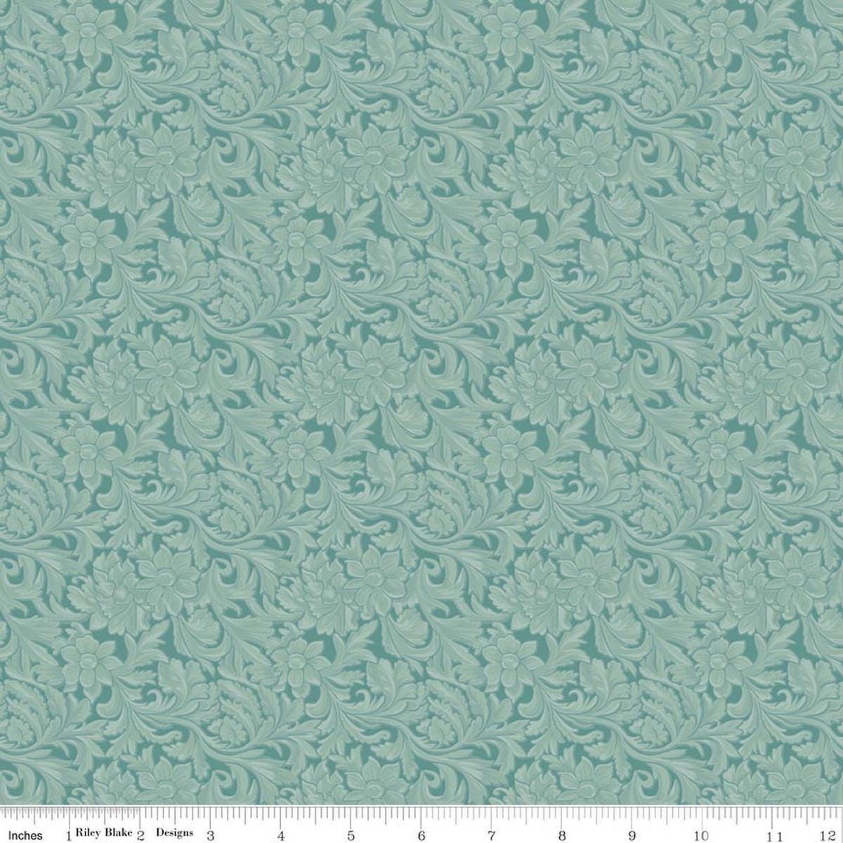 Image of Cowgirl Leather Blue quilting cotton fabric by Echo Park Paper Co. for Riley Blake Designs. Features tone-on-tone flowers on a blue background. Cute Little Fabric Shop.