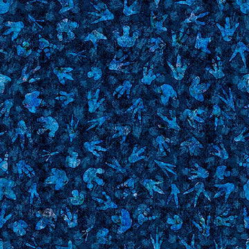 Image of Savage Kingdom Dino Tracks Navy quilting cotton fabric by Dan Morris for QT Fabrics. Features dinosaur footprints on a blue background. Cute Little Fabric Shop.