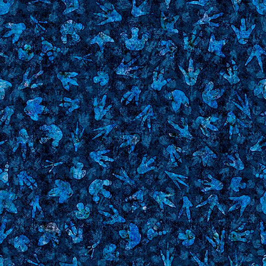 Image of Savage Kingdom Dino Tracks Navy quilting cotton fabric by Dan Morris for QT Fabrics. Features dinosaur footprints on a blue background. Cute Little Fabric Shop.