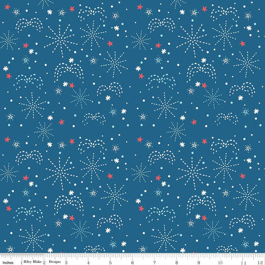 Image of Firework Fields Fireworks Coastal Blue quilting cotton fabric by Gracey Larson for Riley Blake Designs. Features fireworks on a blue background. Cute Little Fabric Shop.