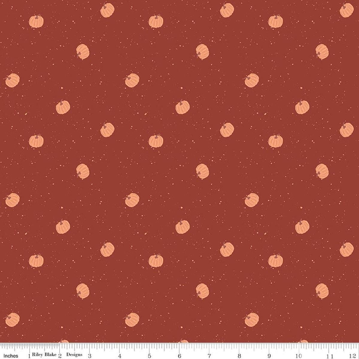 Image of The Apothecary Pumpkin Toss Rust quilting cotton fabric by Amber Elliot for Riley Blake Designs. Features pumpkins on a red background. Cute Little Fabric Shop.